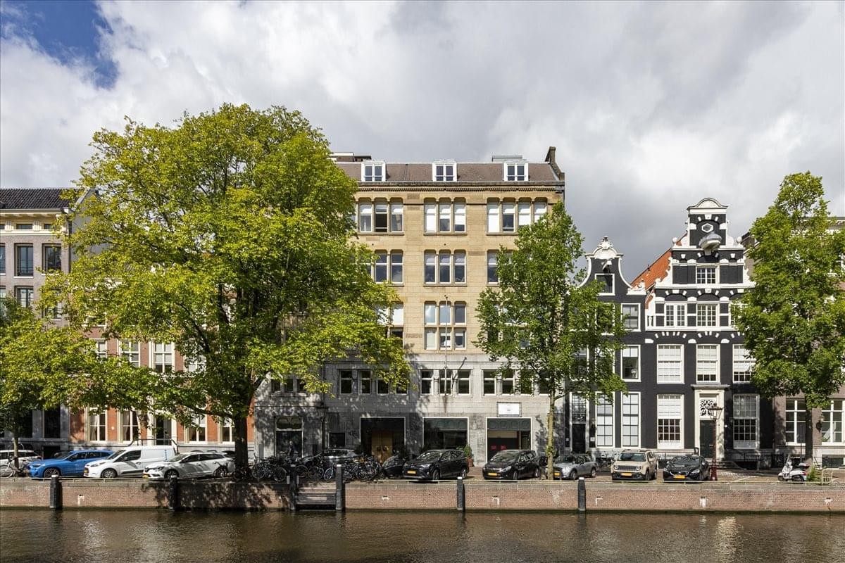Exterior of the historic Herengracht 124-128 building along the canal with traditional Dutch gabled architecture.
