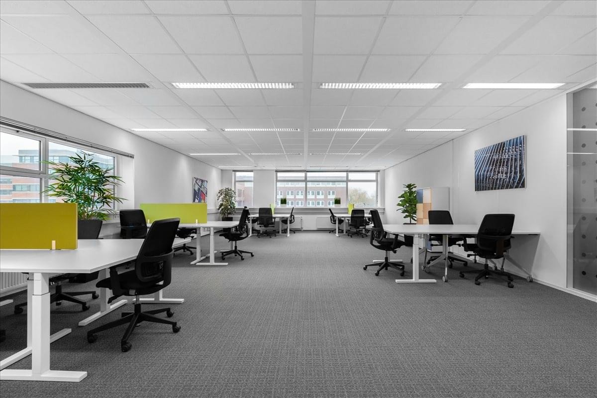 Spacious open-plan workspace at Het Poortgebouw, Beech Ave 54-80 with modern desks and potted plants.