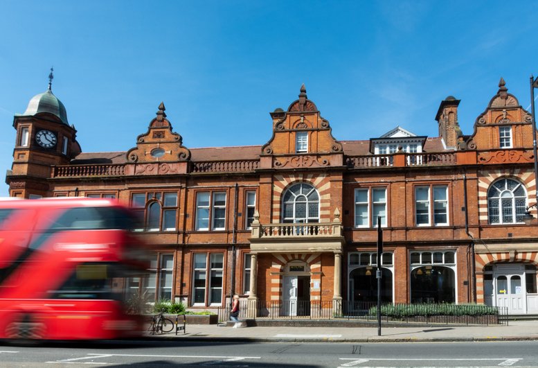 Exterior view of the historic red brick 639 Enterprise Centre featuring a clock tower and ornate facade.