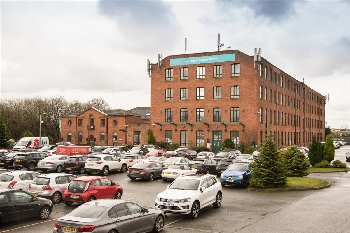 Hollinwood Business Centre exterior view showing the red brick building and car park.