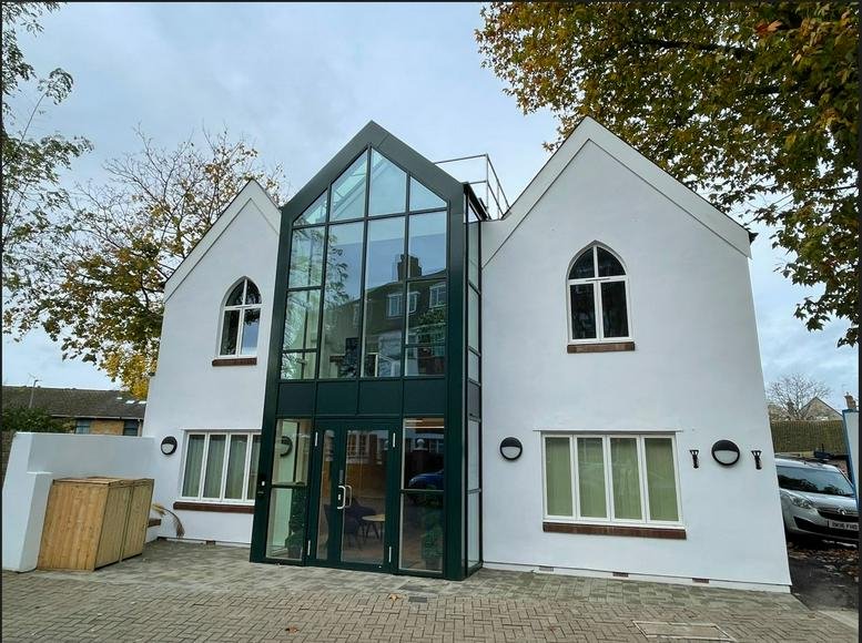 Exterior view of the gabled facade and glass entrance at Hyde Park House, 5 Manfred Road.