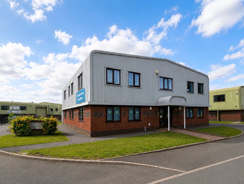 Exterior facade of Storage Giant at Unit 5 Ash Park, Hyssop Close, featuring red brick and grey cladding.