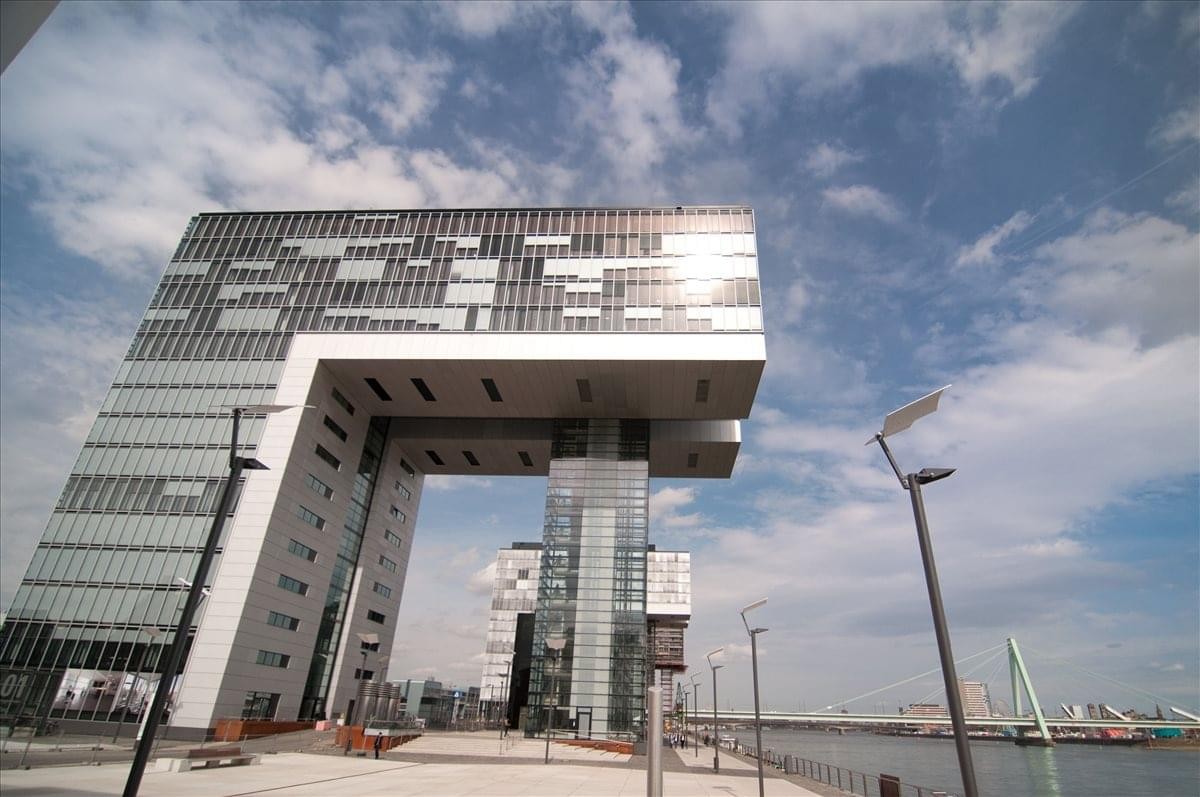 Exterior view of the cantilevered Kranhaus Süd building under a blue sky.