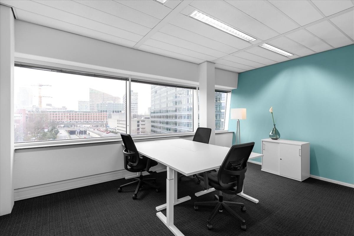 Bright private office suite at Jan Pieterszoon Coenstraat 7 with city views and a feature blue wall.