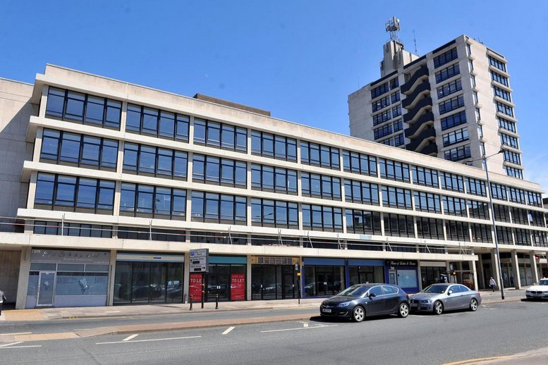 Exterior view of the mid-rise K2 Tower, Bond Street, Hull, United Kingdom against a blue sky.
