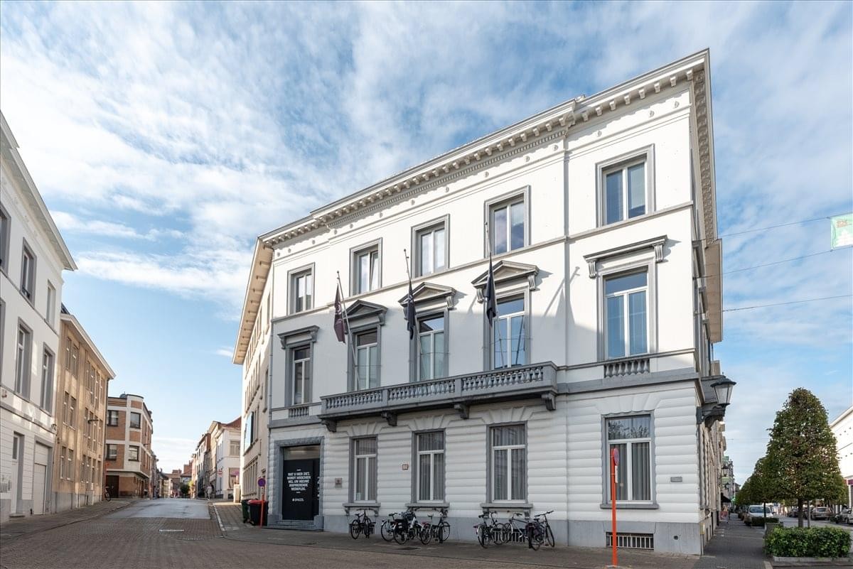 Exterior view of the historic white facade building at Kardinaal Mercierplein 2, Mechelen.