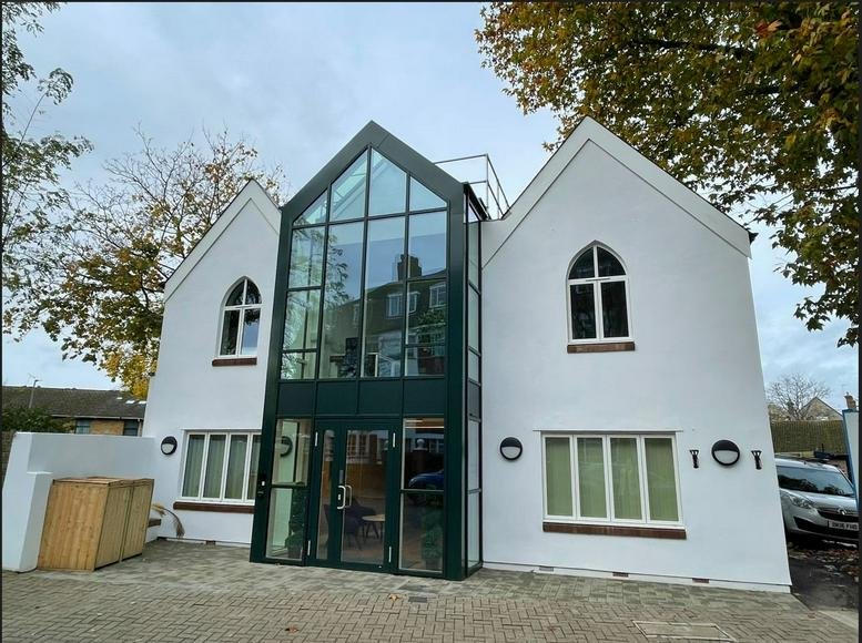 Exterior view of the white facade and glass entrance at Kings Cross Business Centre.