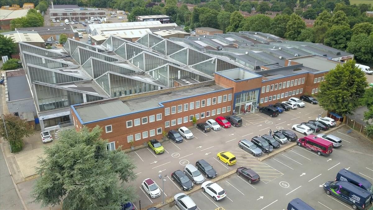 Aerial view of the Kingsfield Way, Gladstone Industry building featuring a large sawtooth roof and car park.