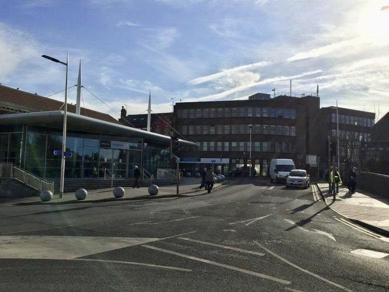 Exterior view of the multi-story brick facade at Kingsley House on a bright day.
