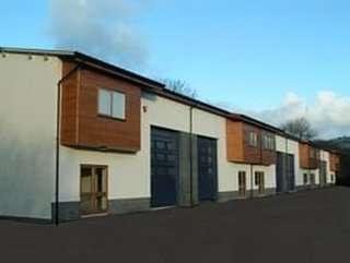 Modern exterior of Kingswood Court Business Park with white walls and distinctive timber-clad upper floors.
