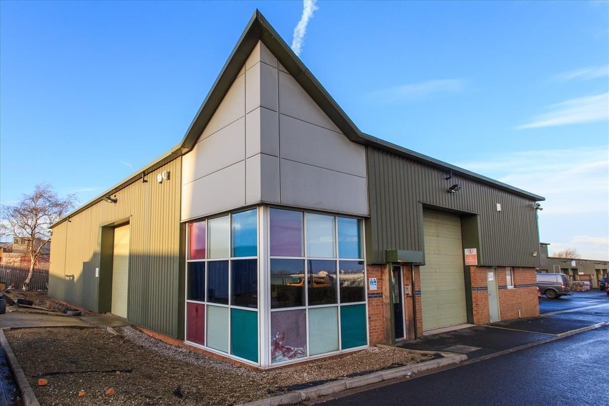 Exterior view of the modern Knowles Lane, Dudley Hill industrial unit with multi-colored glass panels.