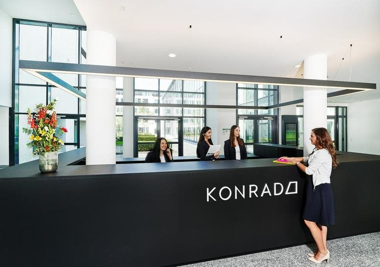 Modern black reception desk with staff at the Konrad-Zuse-Platz 8 business center.