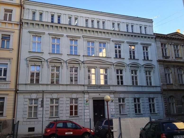 Classic stone facade of the Konventná 9 building with ornate window pediments.