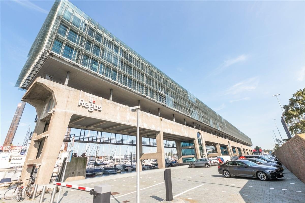 Exterior view of the unique industrial-style Kraanspoor 12-58 building overlooking the water.