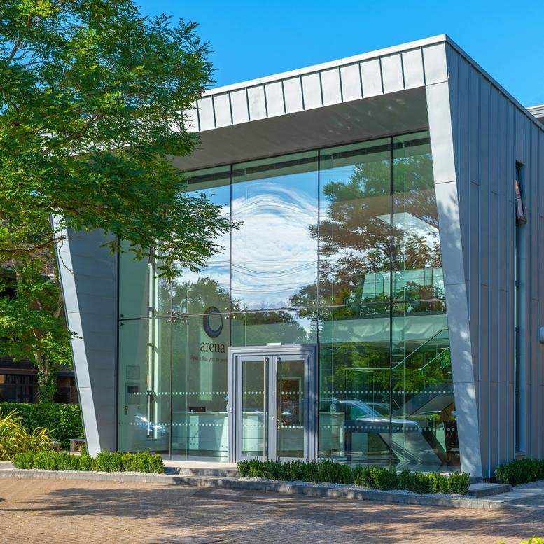 Modern glass and steel exterior of Lancaster Court, 8 Barnes Wallis Road.