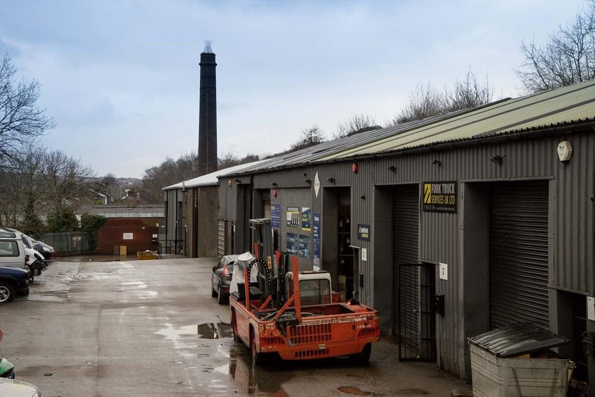 Exterior view of the industrial units and brick chimney at Linthwaite Business Centre.