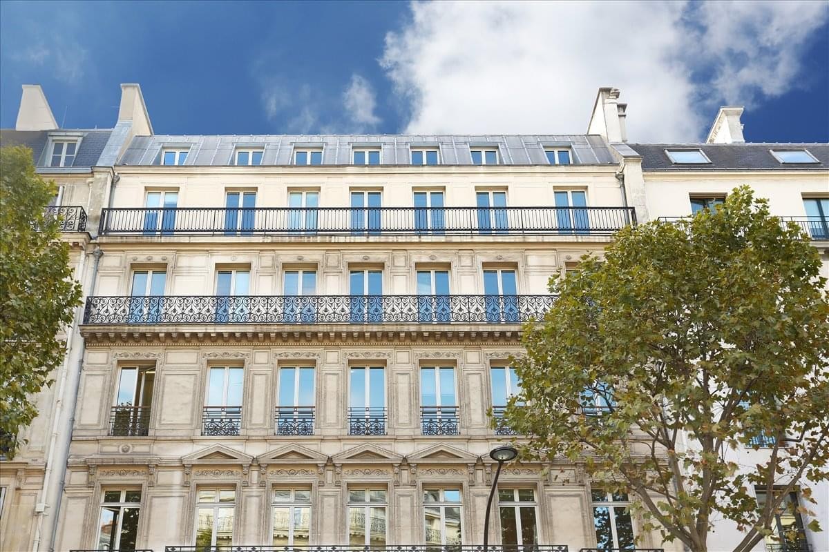 Exterior view of the classic stone facade at Madeleine, 19 Boulevard Malesherbes.
