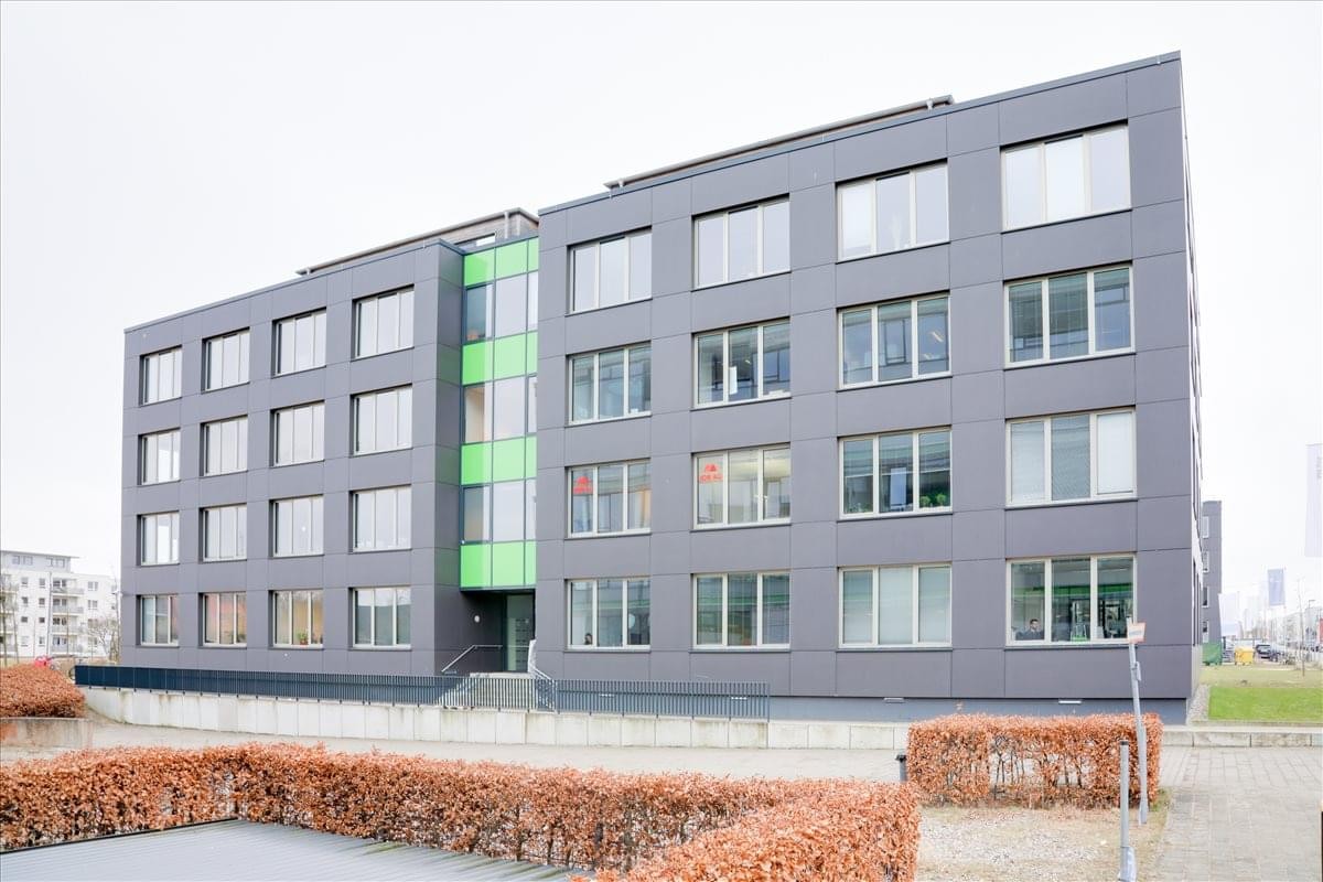 Exterior view of the dark grey modern building facade at Maria-Goeppert Straße 3.