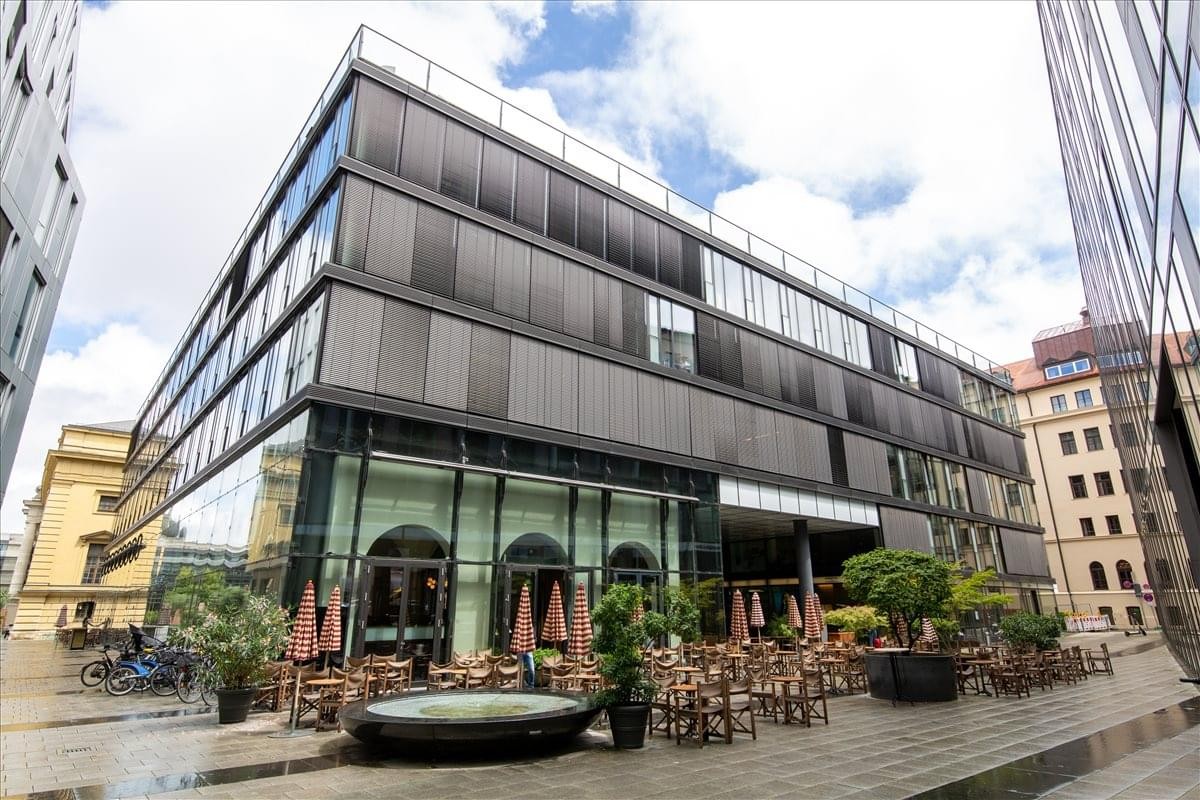 Exterior view of the contemporary dark-framed glass building at Maximilianstraße 13.