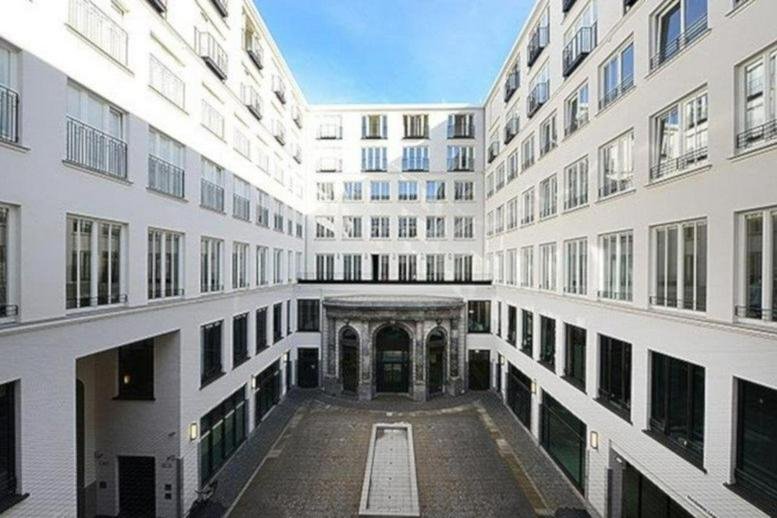 Exterior view of the white facade and courtyard at Maximilianstraße 2, Max-Joseph-Place.