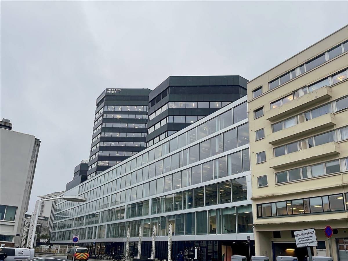 Exterior view of the modern glass and steel facade of Media City Bergen, Lars Hillesgate 30.