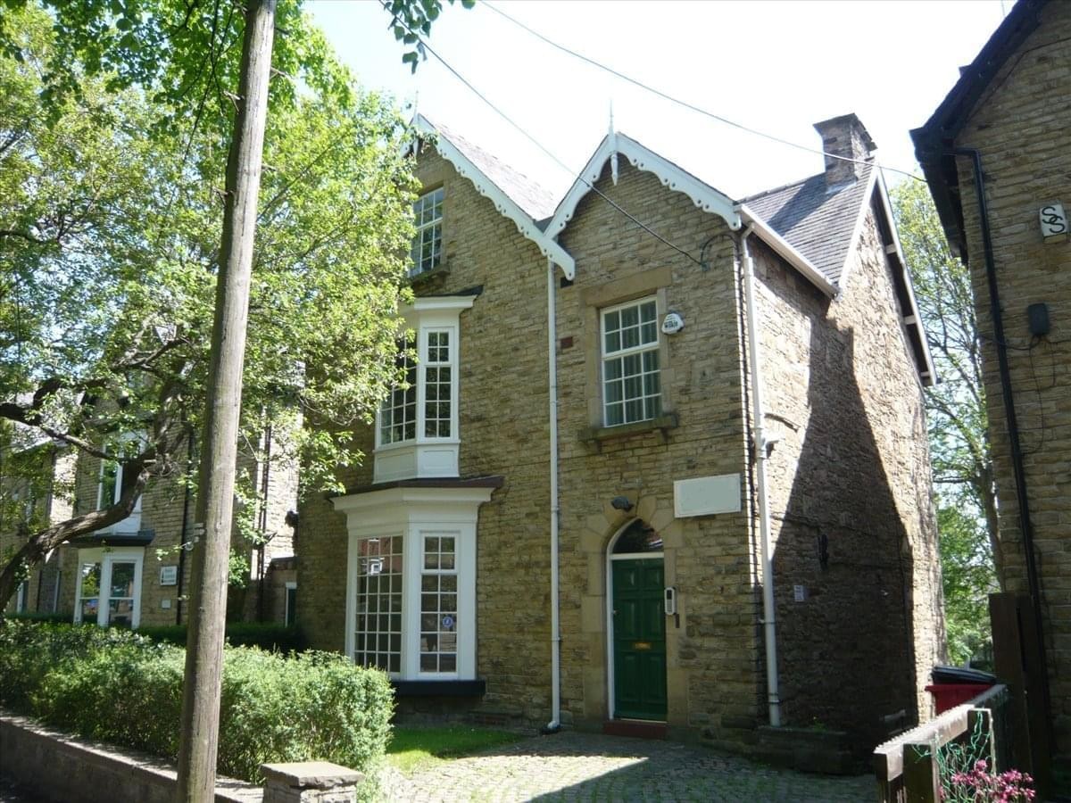 Exterior view of the stone facade and green entrance at Media House, 63 Wostenholm Road.