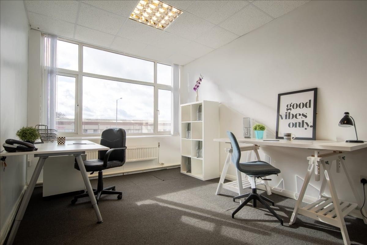 Spacious office suite at Middlefield Industrial Estate, Bedford, Bedfordshire with ample natural light and white desks.