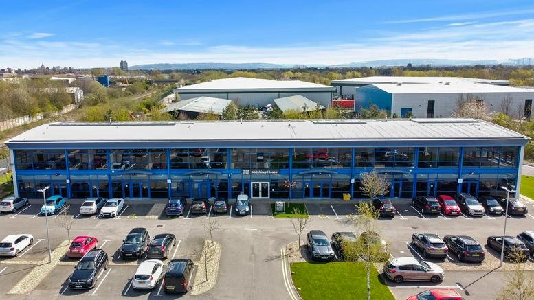 Wide exterior view of Midshires House, 7 Midshires Park, Aylesbury showing the two-story glass facade.