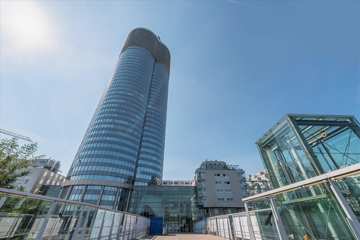 Exterior view of the curved glass facade of the Millennium Tower, Handelskai 94 – 96, Vienna.
