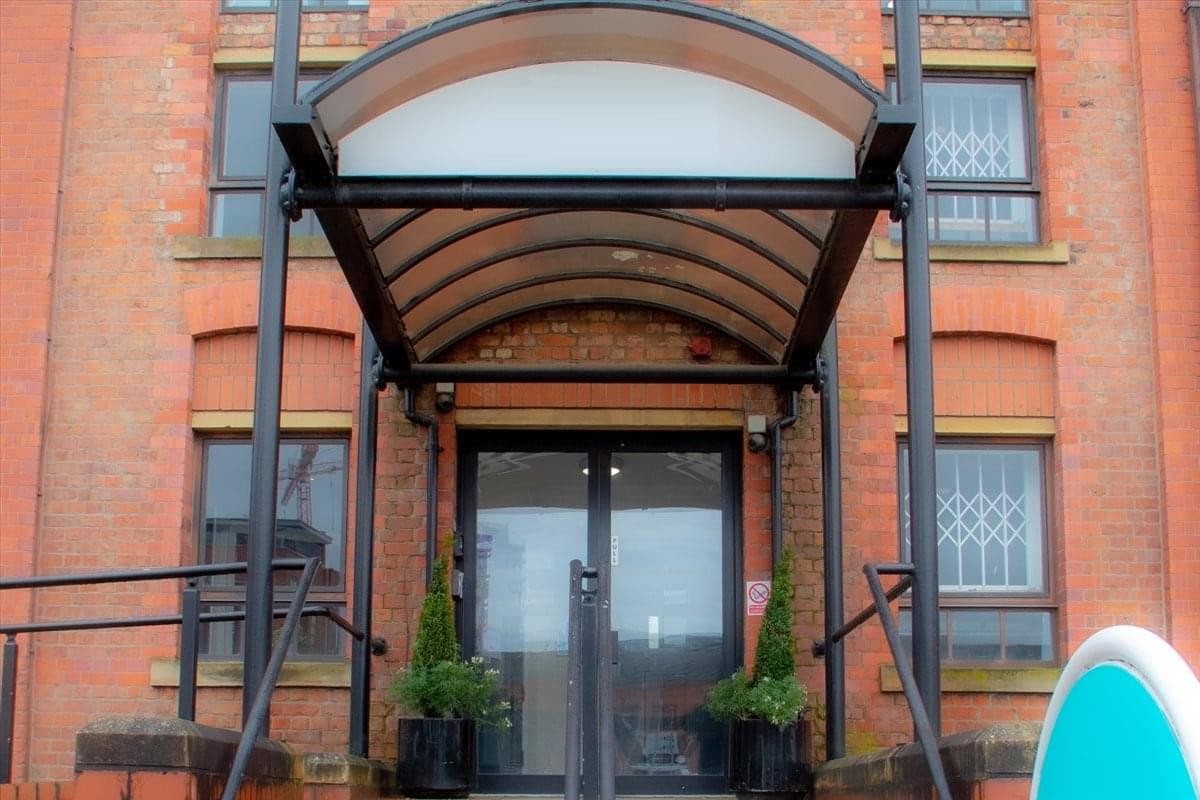 Exterior view of the brick building entrance at Monsall Road, Newton Heath, Manchester.