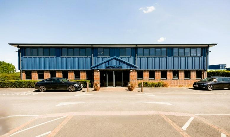 Exterior view of Ashgrove House at Monument Business Park with parking space.