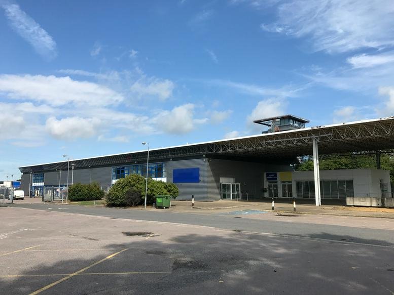 Exterior view of the long, modern industrial-style Motis Business Centre, Cheriton High Street, Kent, Folkestone.