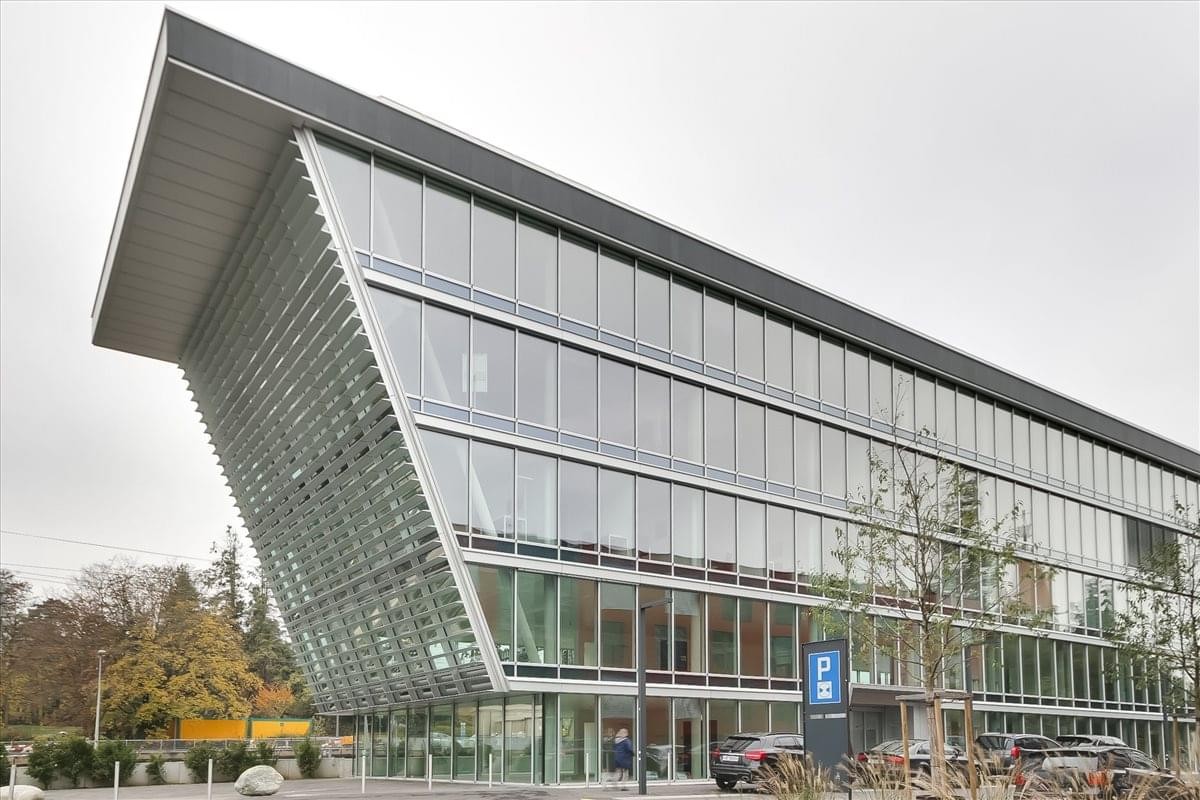 Exterior view of the modern glass-facade Nemaco, Chemin de Terre Bonne 1 building.