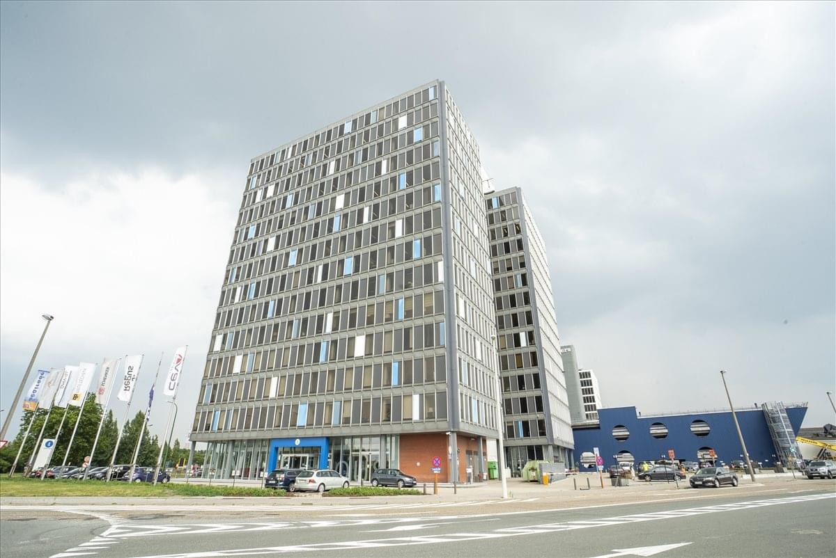 Exterior view of the modern grey high-rise building at Noorderlaan 147, Antwerp.