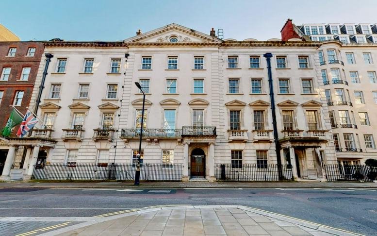 Grand historic stone facade of the Norrtullsgatan 6 building under a soft sky.