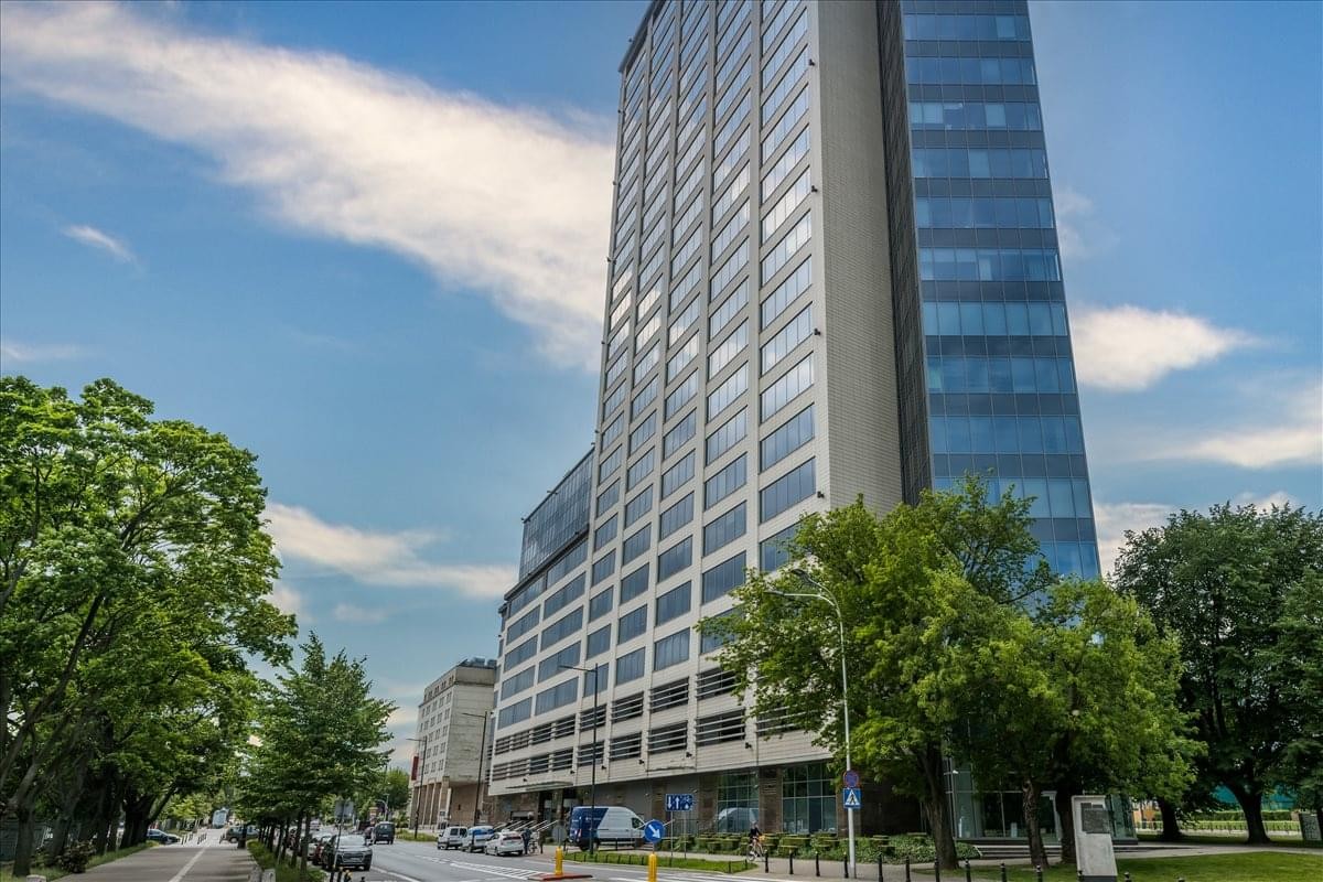 Exterior view of the glass-facade North Gate, Bonifraterska 17 building against a blue sky.