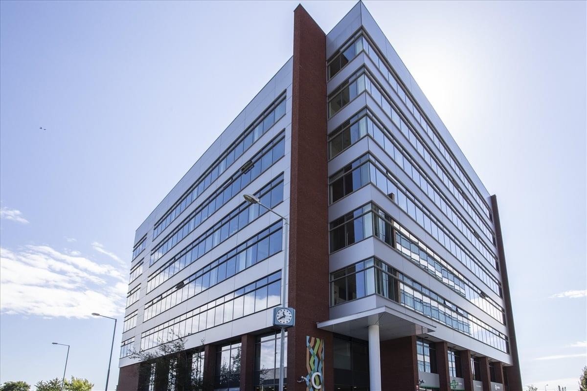 Exterior view of the contemporary glass and brick facade at Nove Butovice, Building C.