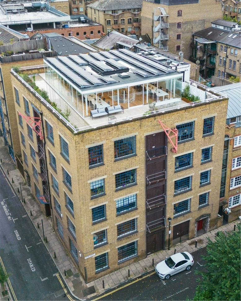Exterior view of the brick facade and glass rooftop extension at Nutmeg House.