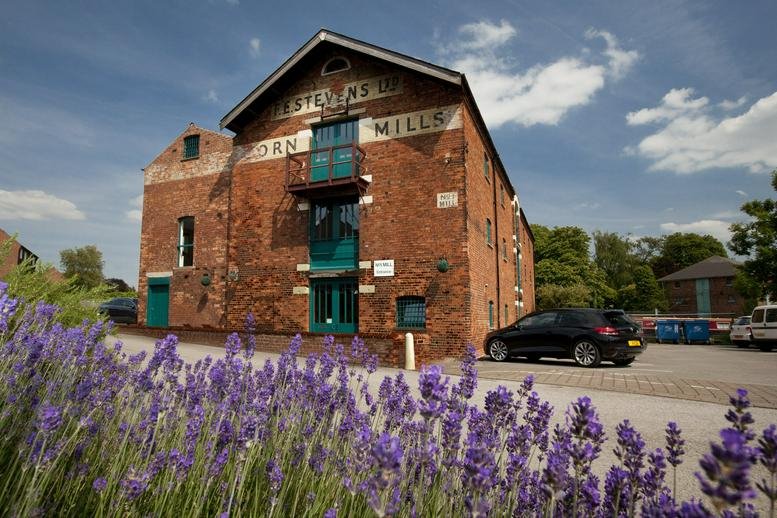 Exterior view of the historic brick building at The Mill, The Wharf, Shardlow.