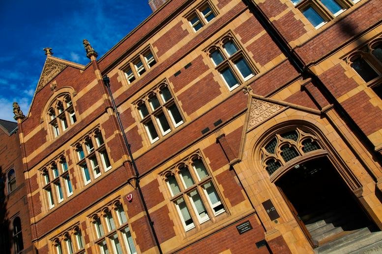 Wide exterior angle of the historic brick building showing Gothic style windows.