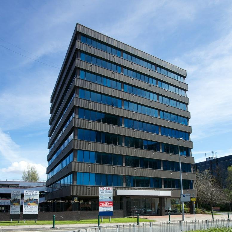 Exterior view of the multi-story brown brick and glass facade of Orbit House, Albert Street.