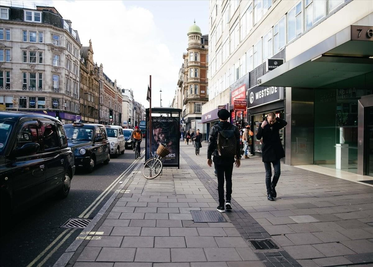 Exterior view of Oxford House, 4th Floor, 76 Oxford Street, Central London on a busy city sidewalk.