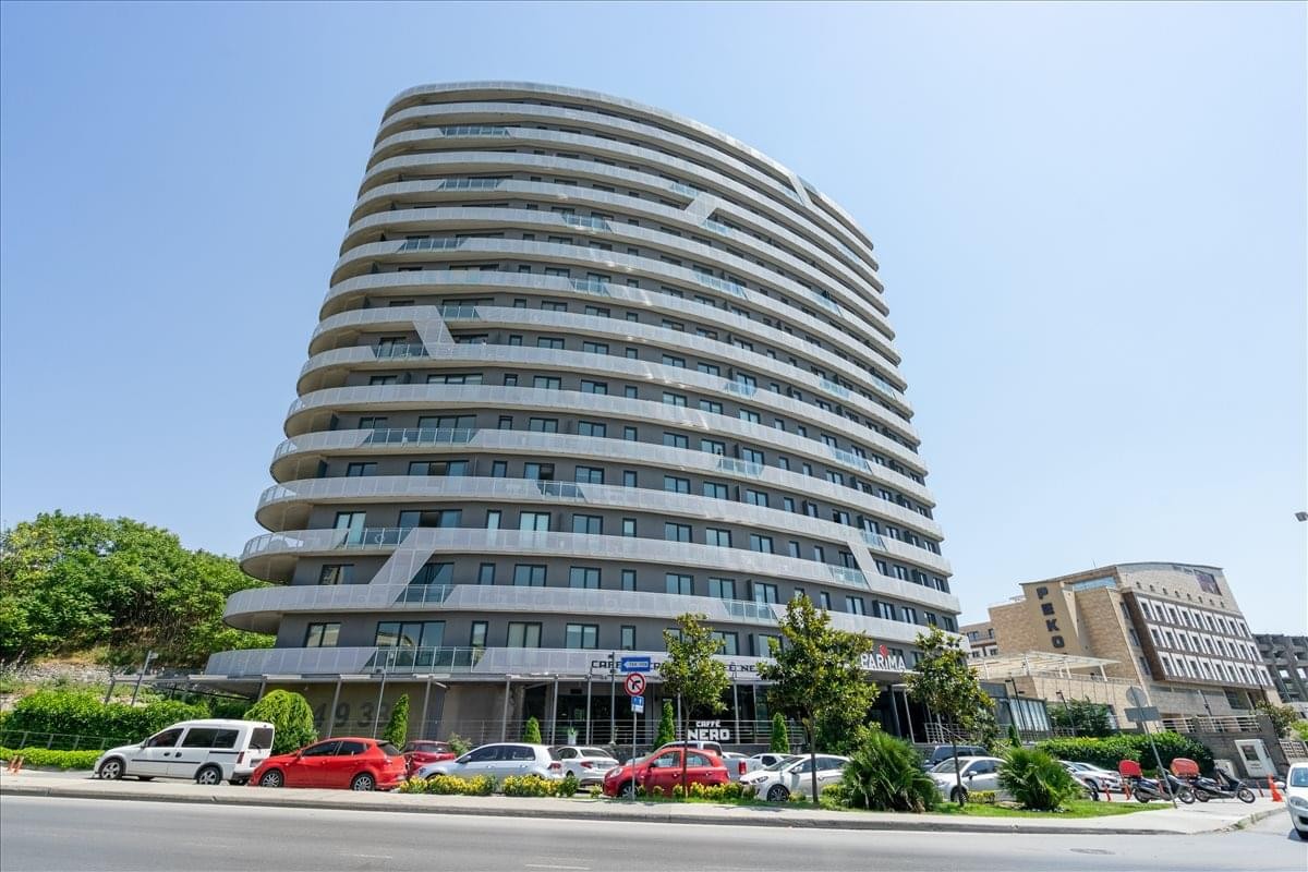 Exterior view of the curved, multi-story Parima Residence building in Istanbul.