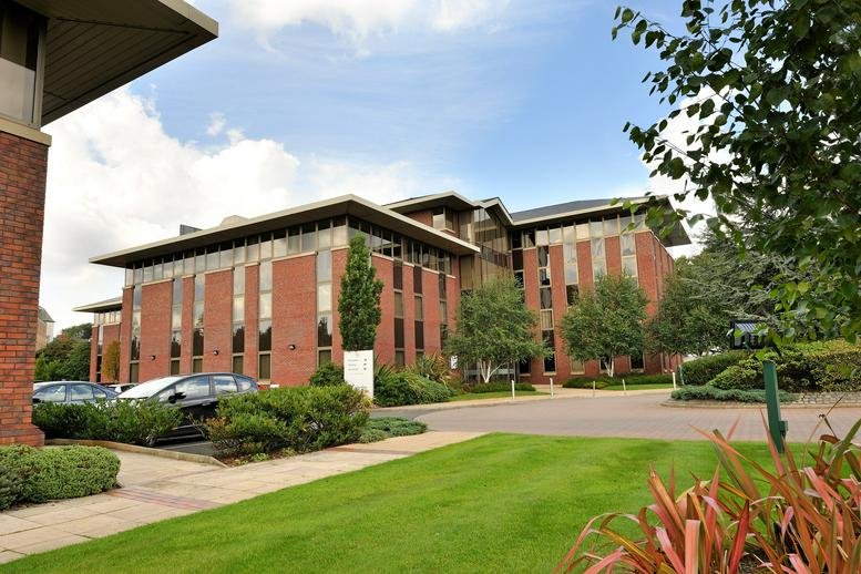 Exterior view of the brick facade and landscaped grounds at Parkway Business Centre, Princess Road.