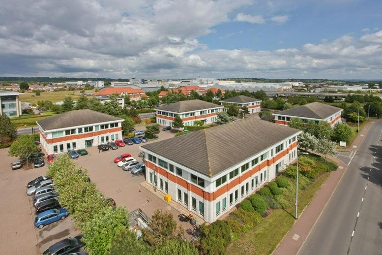 Aerial view of the multi-building office complex and spacious parking lot.