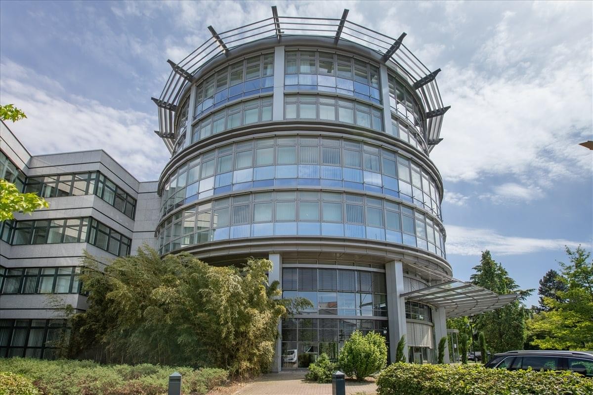Exterior view of the modern, circular glass-facade building of Partnerport near SAP.