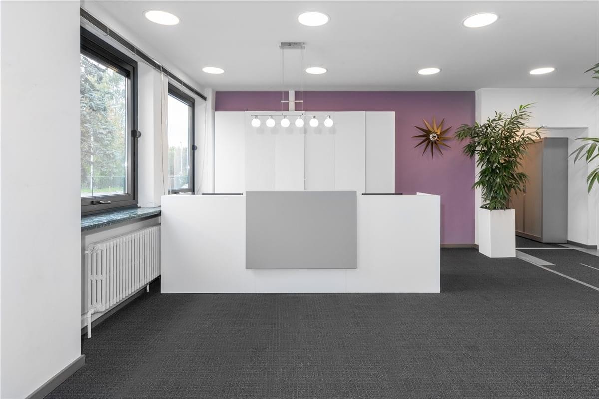 Sleek white reception desk at Pastoor Cooremansstraat 3, Groot-Bijgaarden, Brussels, Belgium.