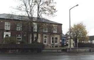 Exterior view of the brick facade at Peel House, 2 Chorley Old Road.