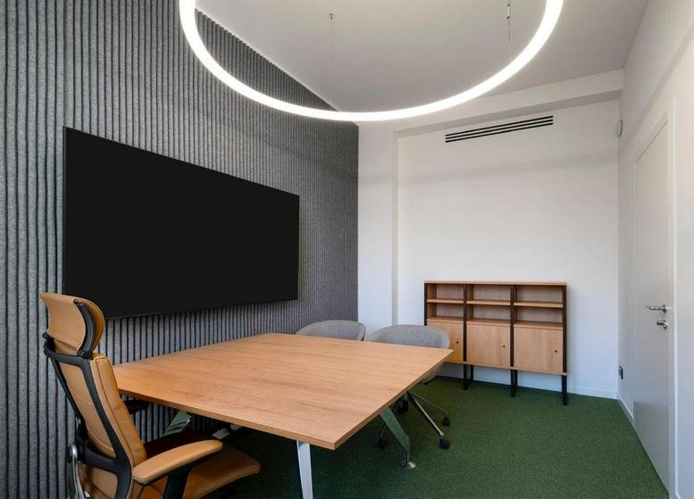 Meeting room at Professional Centre, Piazzetta Guastalla, City Centre, Milan with wood table and acoustic wall.