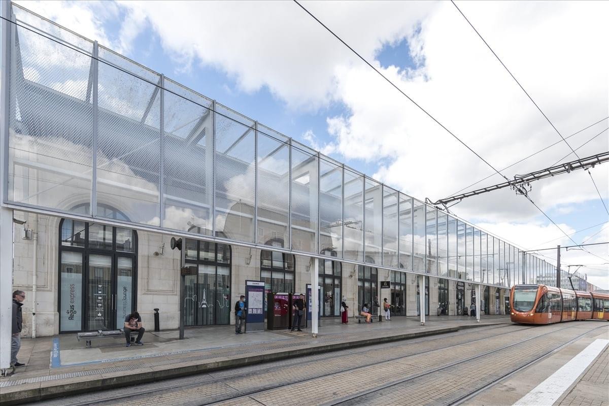 Exterior view of the glass-facade Place du 8 Mai 1945 building at the Le Mans TGV station.